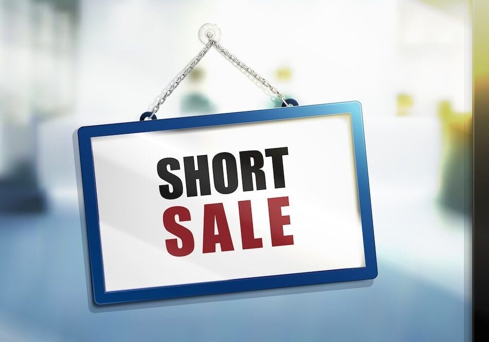 A sign with "SHORT SALE" in bold letters.