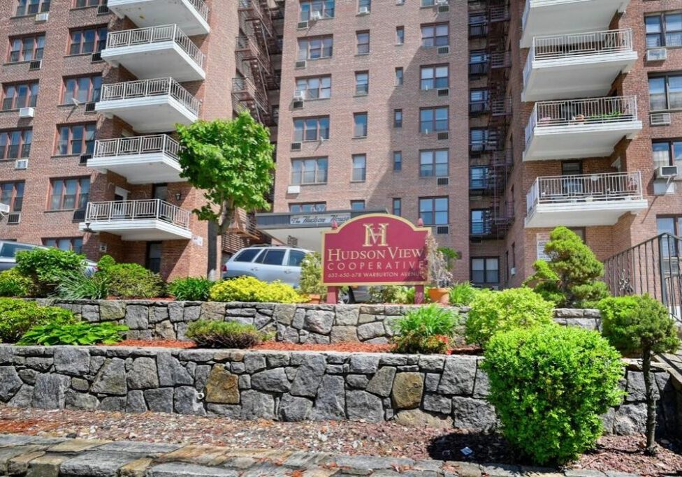 Entrance of Madison at the Glen apartment complex with landscaping.