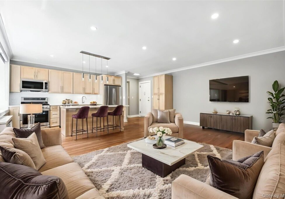 Spacious modern living room with neutral tones and stylish decor.