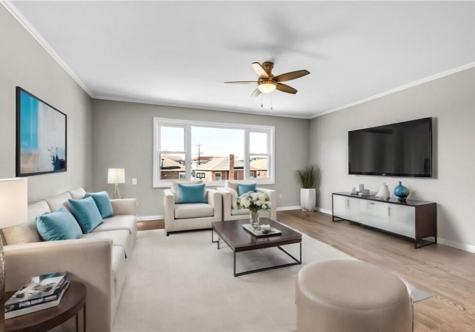 Bright modern living room with neutral tones and blue accents.