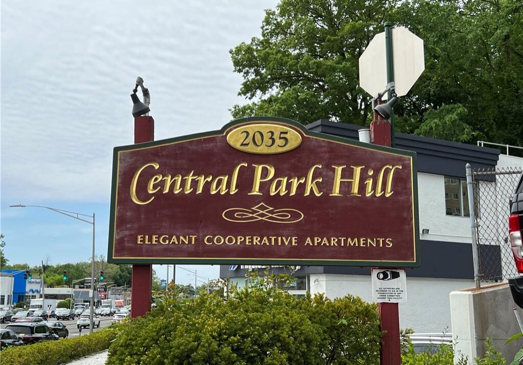 Sign for Central Park Hill apartments in a suburban area.