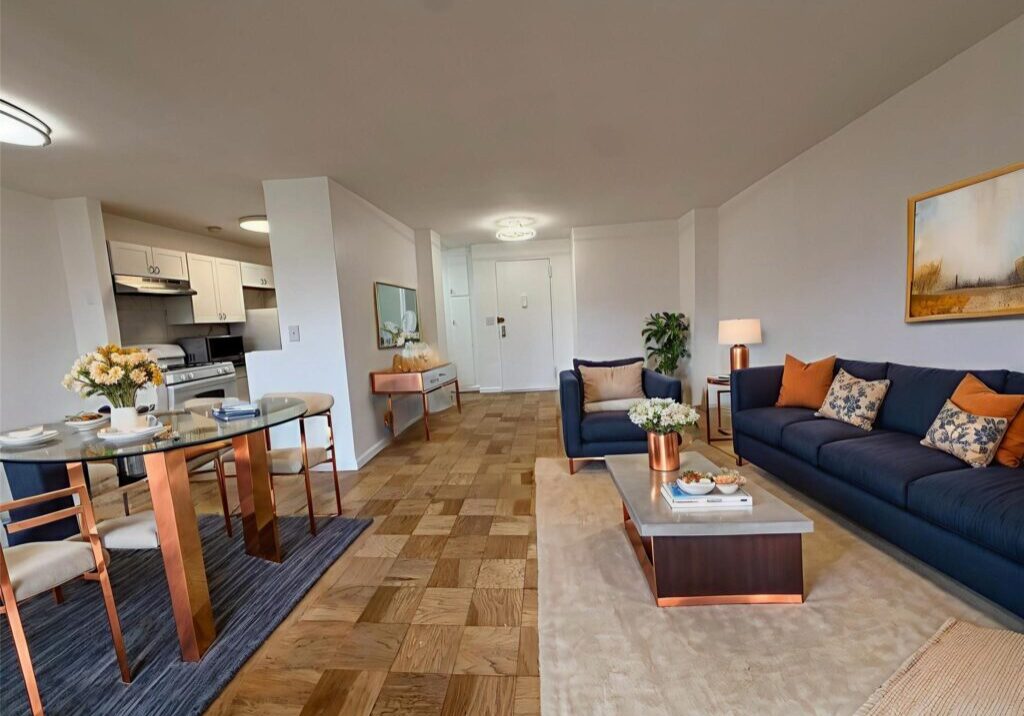 Modern living room with blue sofa and wooden flooring.