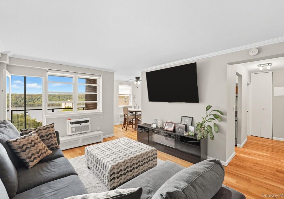 Bright living room with a large TV and modern decor.