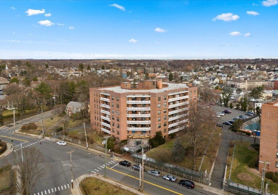 Aerial view of a residential building in an urban area on a clear day.